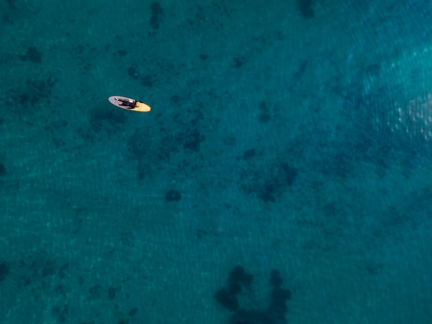 Man laying on surfboard above view