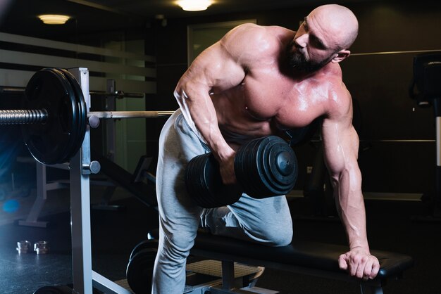 Man leaning on bench press machine