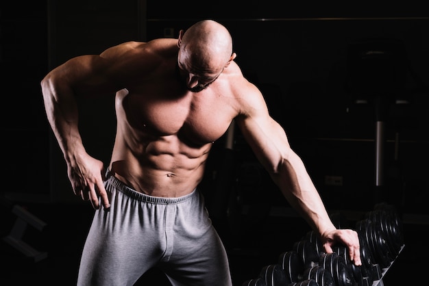 Man leaning on rack and looking down