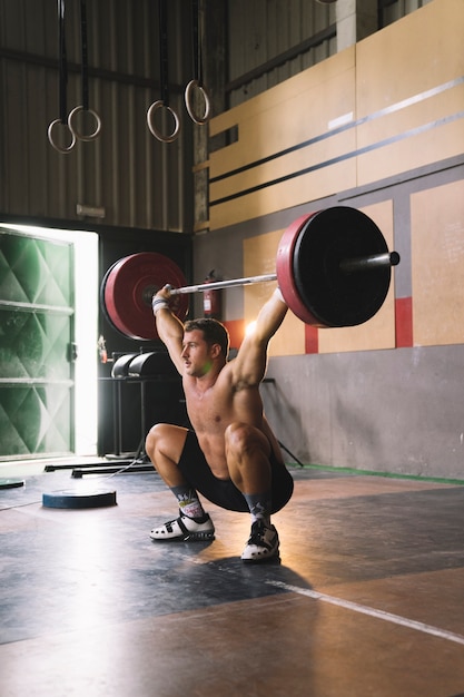 Free photo man lifting barbell