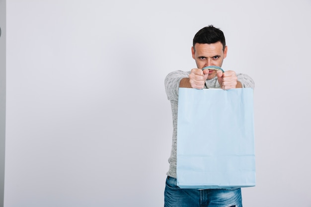 Free photo man lifting shopping bag