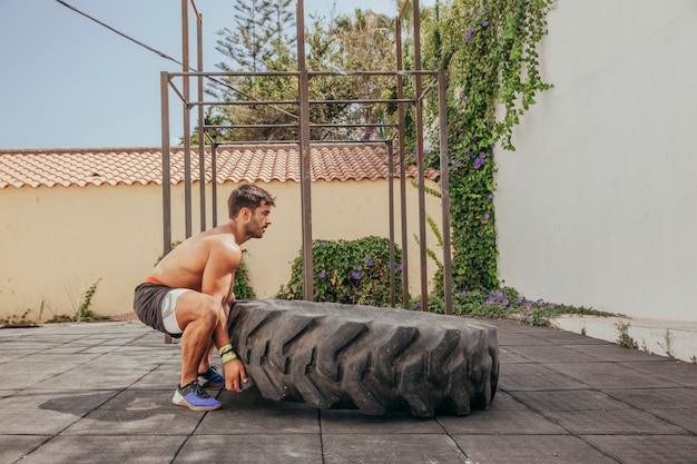 Free photo man lifting wheel