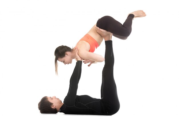 Man lifting woman by the shoulders and hips