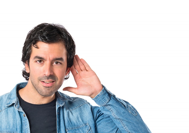 Free photo man listening over isolated white background