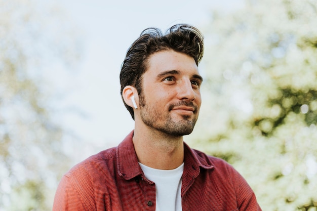 Man listening to music by a wireless earphones