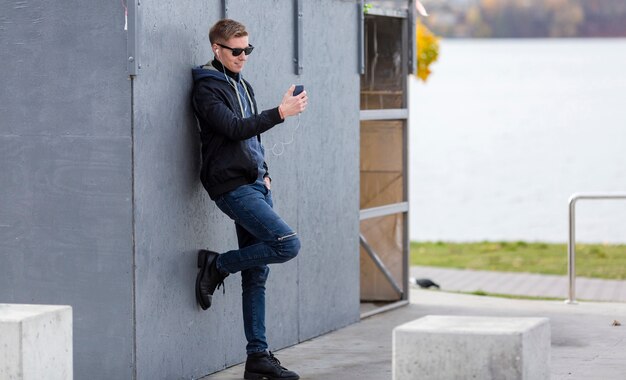 Man listening to music on earphones outdoors