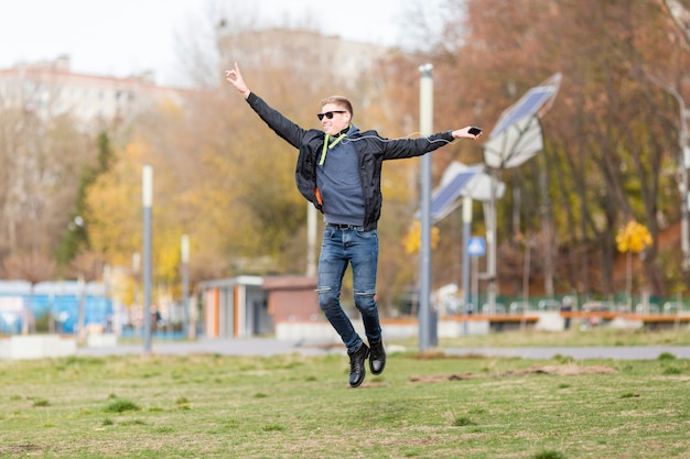 Man listening to music on earphones while jumping