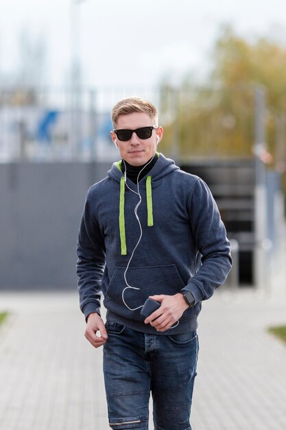 Man listening to music on earphones while running