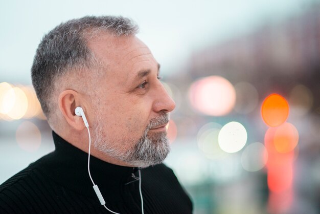 Man listening to music outside with copy space
