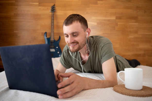 Man listening to music while relaxing in bed