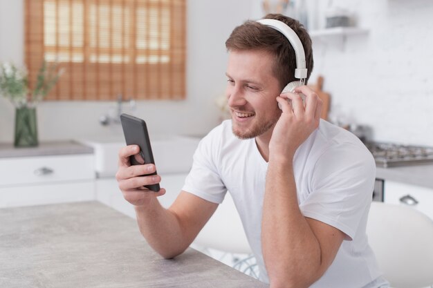 Man listening to music on white headphones