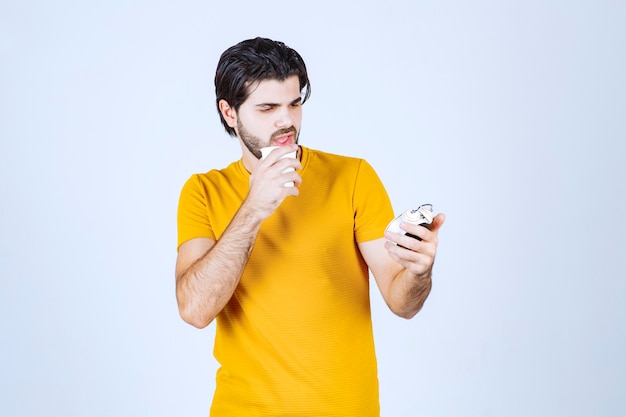 Man looking to an alarm clock and thinking.