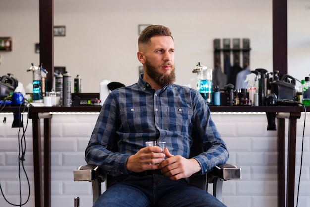 Free photo man looking away at the barber shop