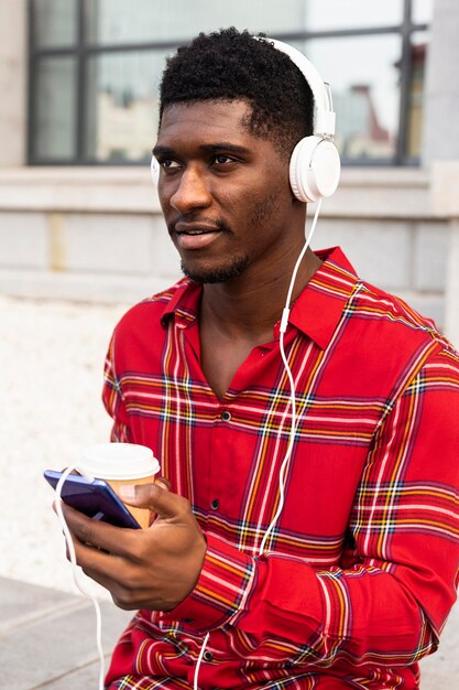 Man looking away while listening to music