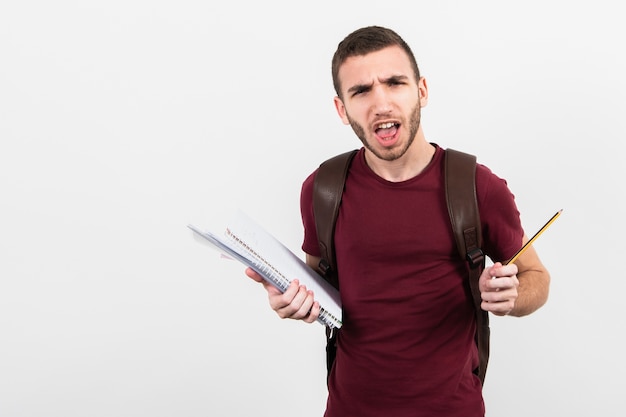 Free photo man looking at camera and holding stationery items