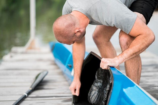 Man looking at canoe