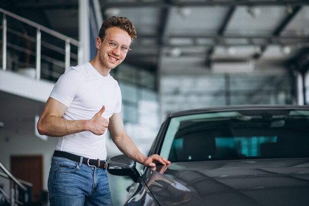 Man looking for a car in a car showroom