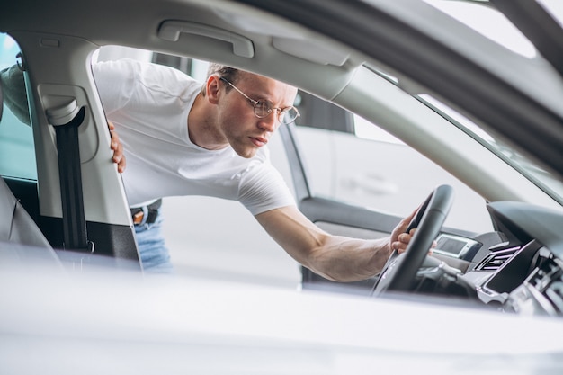 Man looking for a car in a car showroom