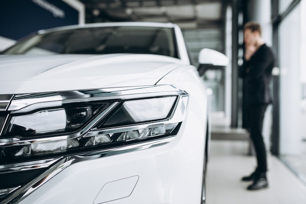 Man looking at a car and thinking of a purchase