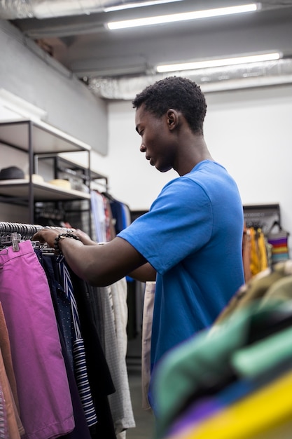 Man looking at clothes side view