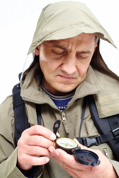 Man looking at compass on trip