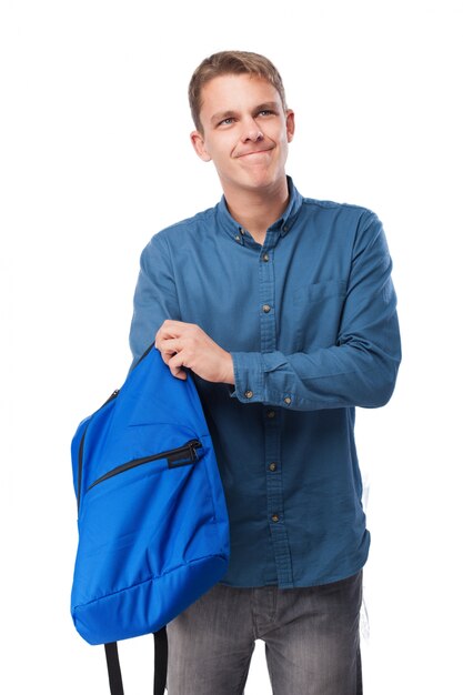 Man looking inside a blue backpack