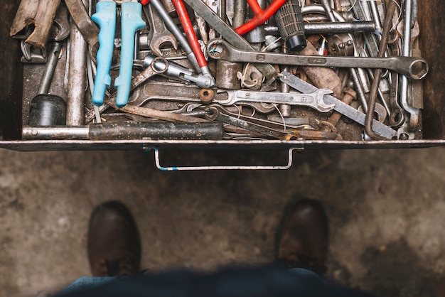 Man looking into drawer full of tools