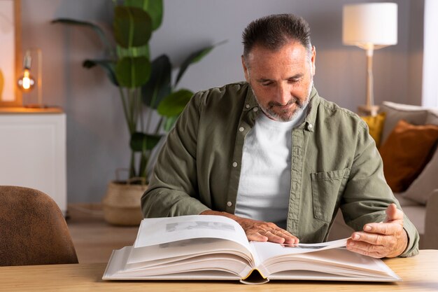 Man looking at picture album front view