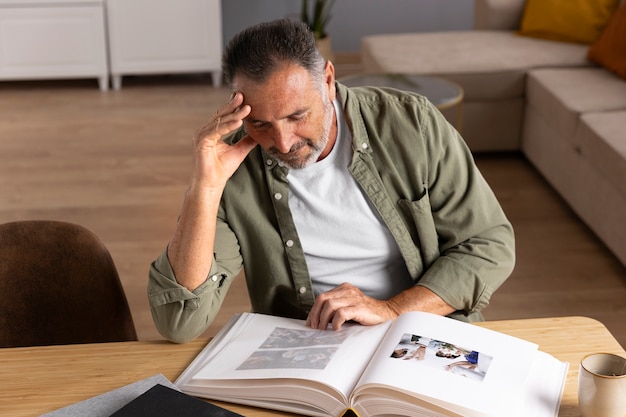 Man looking at picture album high angle