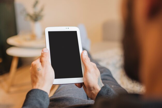 Man looking at smartphone screen at home