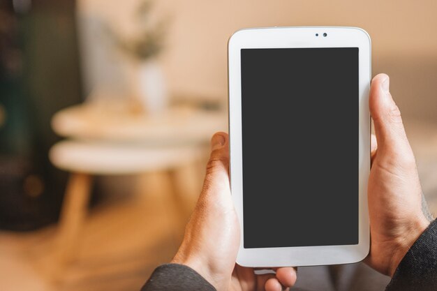 Man looking at smartphone screen at home