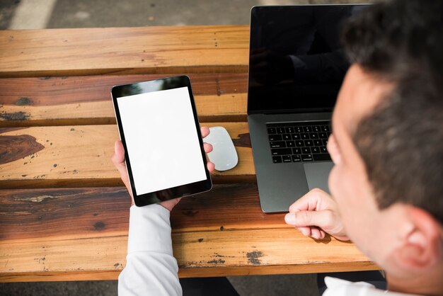 Man looking at tablet outdoors