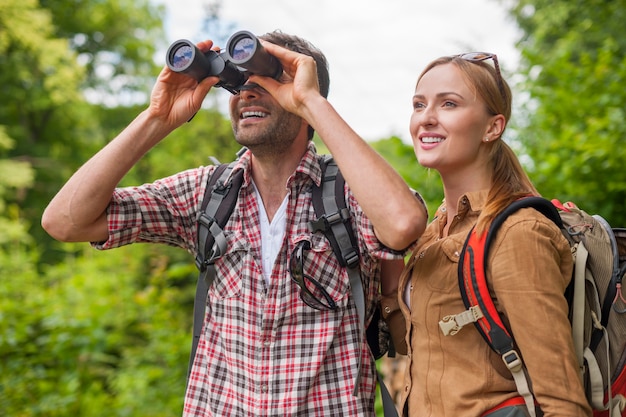 Free photo man looking through the binoculars. hiking time