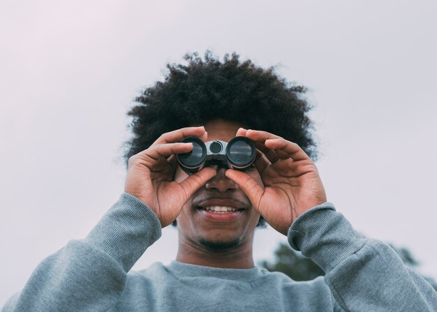 Man looking through binoculars