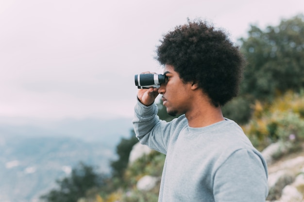 Man looking through binoculars