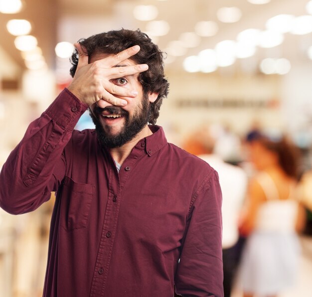 Man looking through fingers