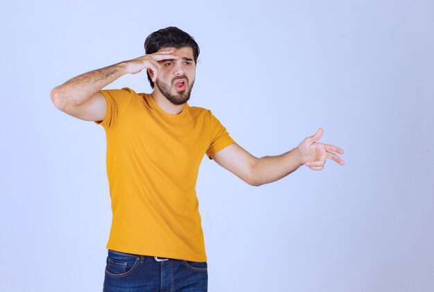 Man looking through his fingers