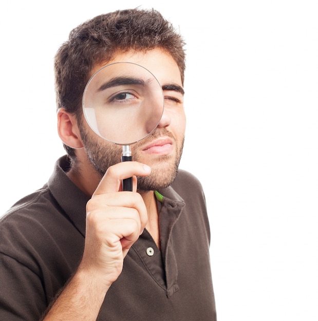 Man looking through a magnifying glass