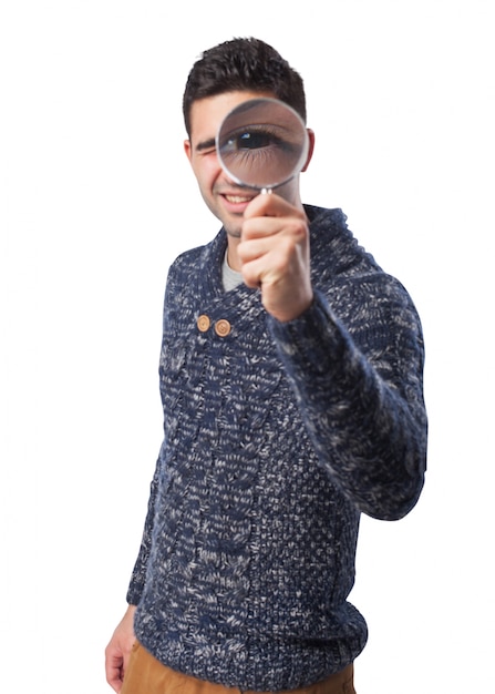 Man looking through a magnifying glass