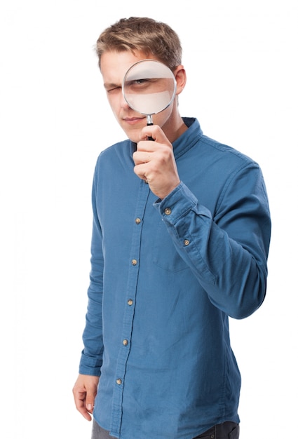 Man looking through a magnifying glass