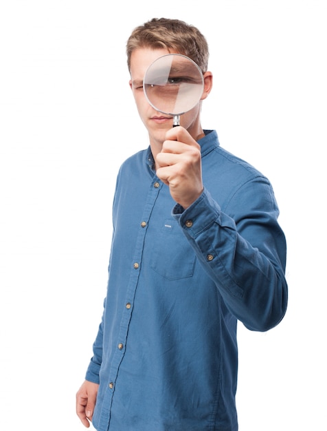 Man looking through a magnifying glass