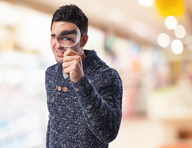 Man looking through a magnifying glass