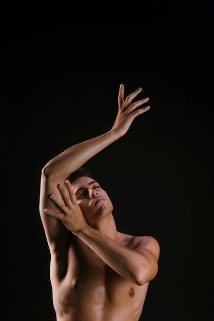 Man looking up and gently pulling hands