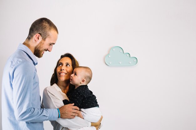 Man looking at wife and baby