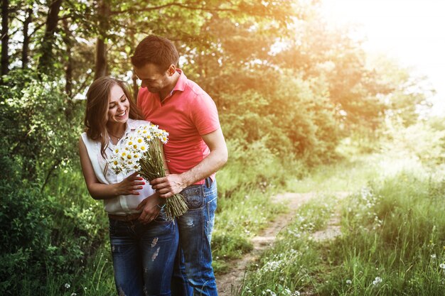 Man in love giving a bouquet of daisies