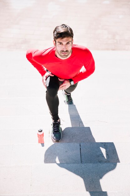 Man lunging and looking at camera