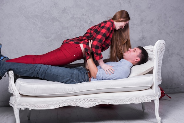 Man lying on sofa with woman 