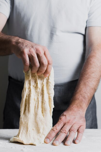 Man making dough for bread front view