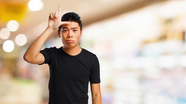 Man making the gesture of "loser"