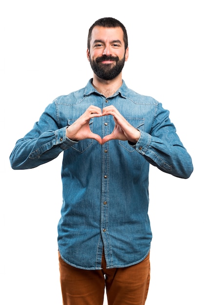 Free photo man making a heart with his hands